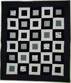 a black and white quilt with squares on it