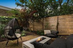 an outdoor living area with furniture and fire pit