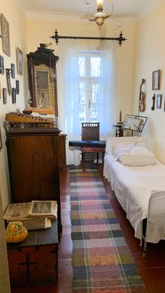 a room with two twin beds, a dresser and a mirror on the wall in it