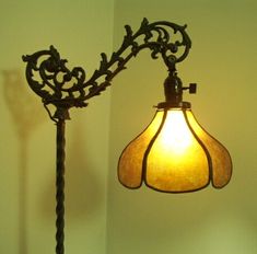 a lamp that is on top of a table next to a light fixture with a glass shade