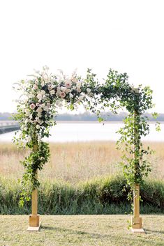 an outdoor ceremony setup with flowers and greenery