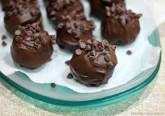 chocolate desserts are arranged on a glass plate