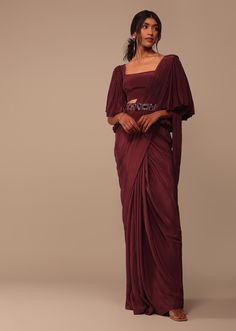 1. Saree: The soft organza fabric gives the saree a lightweight and elegant feel. Maroon is a rich and classic color choice that can be both traditional and modern. 2. Blouse with Flare Sleeves: The blouse with flare sleeves adds a touch of drama and fashion-forward style to the outfit. Flare sleeves can vary in length, ranging from short to long, and they create a statement look. 3. Handwork Belt: The handwork belt serves as an accessory that not only enhances the waistline but also adds a personalized and intricate touch to the ensemble. Handwork can include embroidery, beadwork, sequins, or other decorative elements. This combination of elements reflects a fusion of traditional Indian saree attire with contemporary and trendy design elements. Indo-western outfits are known for blending Haldi Clothes, Sari Designs, Soft Organza Saree, Cinderella Fashion, Bestie Poses, Indo Western Saree, Trendy Kurti, Sari Design, Lehenga Designs Simple