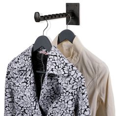 two shirts are hanging on a coat rack with clothes hangers in front of them