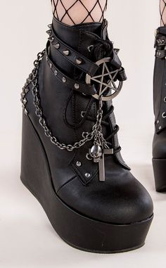 The Poison wedge series feature wickedly stylish designs. Cages and cute charms and chains, oh my! Vegan Black PU leather 5 inch platform Ankle bootie Pentagram charm Studded straps Side zip Studded heel Chains with cross charms Lace up U.S women's sizing-refer to size chart for more info Platform Goth Boots, Gothic Platform Ankle Boots, Boots With Chains, Alternative Boots, Goth Heels, Goth Platform Boots, Demonia Boots, Platforms Shoes, Alternative Shoes