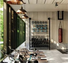 an indoor gym with several exercise bikes in the center and one on the floor, surrounded by wooden planks