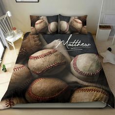 a bed with baseballs on it and the name matttew written in white