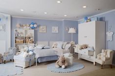 a child's bedroom with blue walls and furniture, including teddy bears on the bed