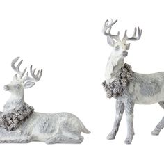 two white deer statues sitting next to each other