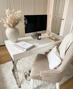 a white desk with a computer on it