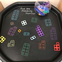 a black tray with colorful dices on it and the words find the matching numbers