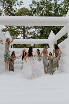 a group of women standing around each other in front of an inflatable structure