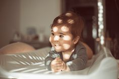 a small child laying on top of a bed