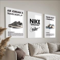 three posters hang on the wall above a couch in a living room with white furniture