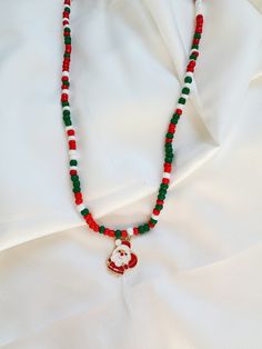 🎄 Embrace the holiday spirit with our Christmas Color Beaded Necklace featuring a charming metal Santa pendant! 🎅Handcrafted with love, this festive accessory blends the classic colors of Christmas - vibrant reds and lush greens - into a harmonious symphony of holiday cheer. 🌟 The star of the show is our small, adorable Santa pendant, adding a touch of whimsy and merriment to your ensemble. Crafted with attention to detail, this jolly Santa brings a sprinkle of magic to your festive look. ✨ Versatile and lightweight, this necklace is perfect for holiday parties, family gatherings, or simply adding a touch of Christmas joy to your everyday wear. It also makes a delightful gift for loved ones, spreading warmth and good cheer. 🎁 Packaged with care, our Christmas Color Beaded Necklace with Color Beaded Necklace, Pearl Threader Earrings, Holiday Bracelets, Green Beaded Necklace, Christmas Color, Jolly Santa, Snowflake Earrings, Christmas Bracelet, Necklace Red