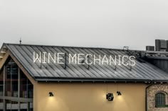 a sign that reads wine mechanics on top of a building