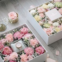 two white boxes with pink and white flowers in them