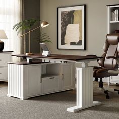 an office with a desk, chair and bookcase in the middle of it is shown