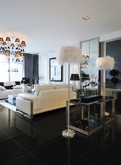 a living room filled with white furniture and lots of windows