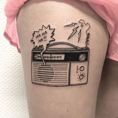 a woman's thigh with a radio tattoo on it