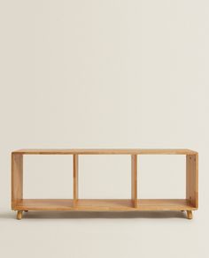 a wooden shelf with three shelves on each side