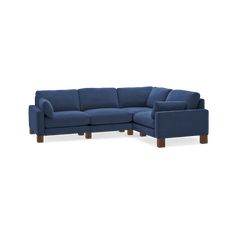 a blue sectional couch sitting on top of a white floor