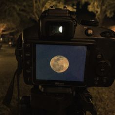 a camera with a full moon in the background