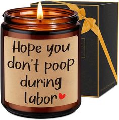 a candle that says hope you don't poop during labor next to a box