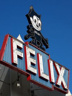 a large sign on top of a building that says netflix and has a cat figure above it