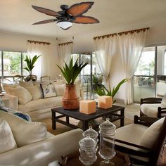 a living room filled with furniture and a ceiling fan