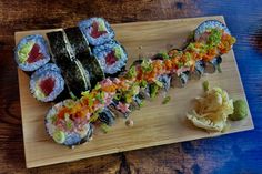 sushi is served on a wooden platter