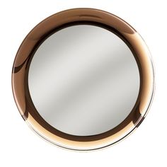 a round mirror is shown on the wall