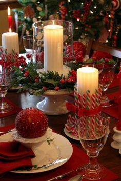 a christmas table setting with candles and candy canes