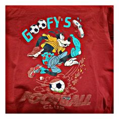 the back of a red shirt with goofy's cartoon character on it and a soccer ball