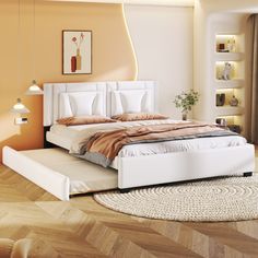 a white bed sitting on top of a hard wood floor next to a wall mounted clock