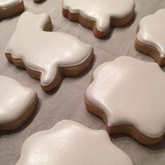 iced cookies with white icing are on a baking sheet and ready to be baked