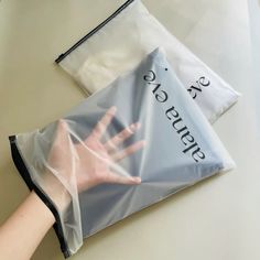 a person's hand in a plastic bag on top of a white countertop