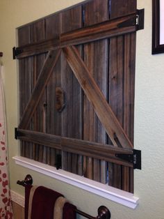 an old barn door is hung on the wall above a towel rack in this bathroom