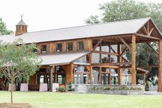 a large wooden building sitting on top of a lush green field