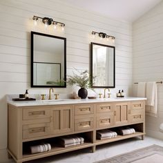 a bathroom with two sinks and mirrors on the wall