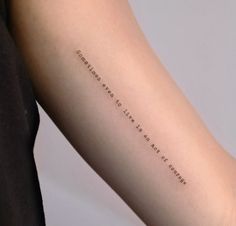 a woman's arm with a quote on it