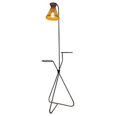 a lamp that is on top of a metal stand with a light bulb attached to it