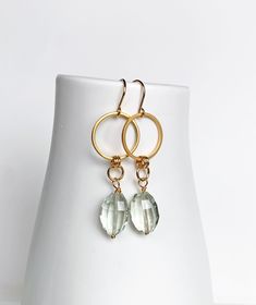 Modern, luxe earrings featuring beautiful faceted green amethyst gemstones. These earrings are great for work or everyday wear. Lovely pale green is a hit for spring. + Green Amethyst. 14K Gold Fill Ear Wire. 14K Gold Plate Circle. + Length: 2 inches. + Earrings are ready to ship. + Your jewelry will come in a jewelry box, tied with a ribbon. ➤➤ Have a question about this product, reach out to me here ➙ https://www.etsy.com/conversations/new?with_id=9057464&referring_id=5772224&referring_type=sh Elegant Handmade Green Amethyst Jewelry, Luxury Green Amethyst Earrings As Gift, Elegant Green Amethyst Earrings For Gift, Dangle Earrings With Green Amethyst Gemstone, Luxe Earrings, Faceted Green Amethyst Earrings Gift, Green Amethyst Gemstone Dangle Earrings, Green Amethyst Jewelry, Elegant Faceted Green Amethyst Earrings