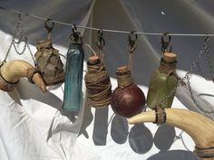 an image of a bottle that is hanging from a line with other items attached to it