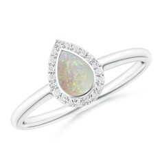 a white gold ring with an opal and diamonds