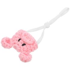 a pink crocheted elephant ornament hanging from a white string on a white background