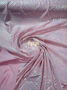 the fabric is shiny and pink with some silver foil on it's surface,