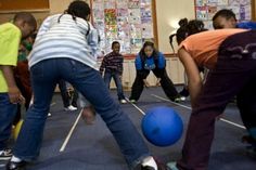 a group of people playing with a ball in a room