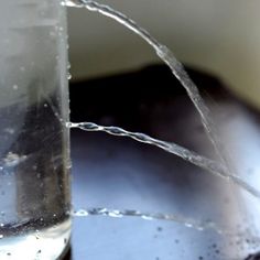 a glass filled with water sitting on top of a table