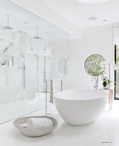 a white bathroom with a large bowl sink